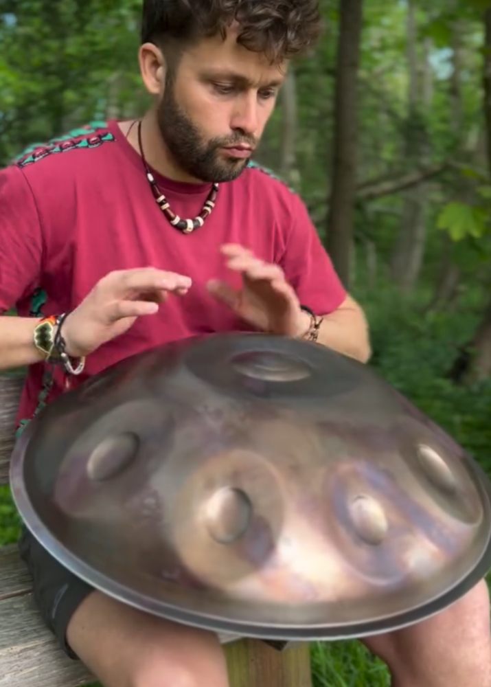 LIDAH HANdpan being played by a young man outside