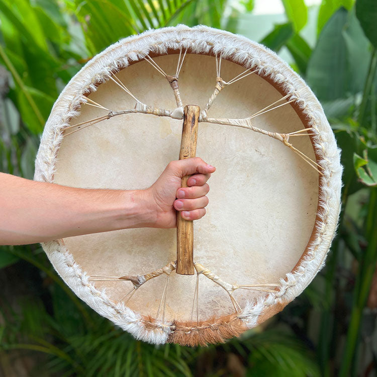 Musician playing Shaman Drum during sound healing ceremony
